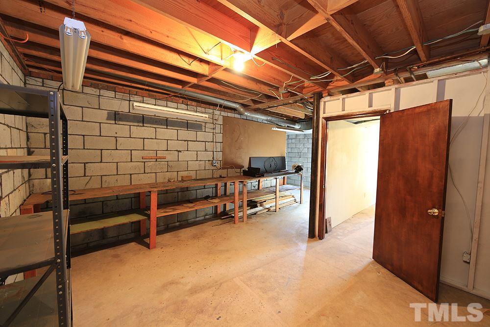 4316 Oak Park Road Raleigh, NC 27612 - Photo 21 of 30 a view of outdoor space with wooden shelves