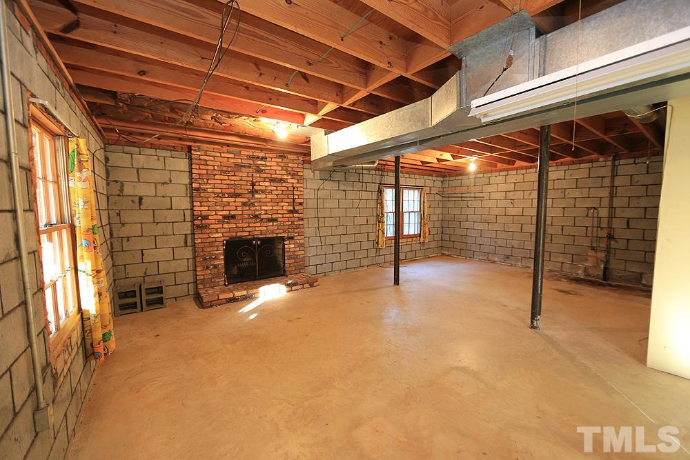 4316 Oak Park Road Raleigh, NC 27612 - Photo 22 of 30 a view of an empty room with a fireplace