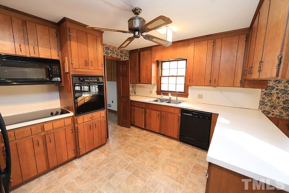4316 Oak Park Road Raleigh, NC 27612 - Photo 6 of 30 a kitchen with stainless steel appliances a stove sink and cabinets