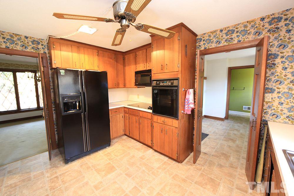 4316 Oak Park Road Raleigh, NC 27612 - Photo 7 of 30 a kitchen with stainless steel appliances granite countertop a refrigerator and a sink