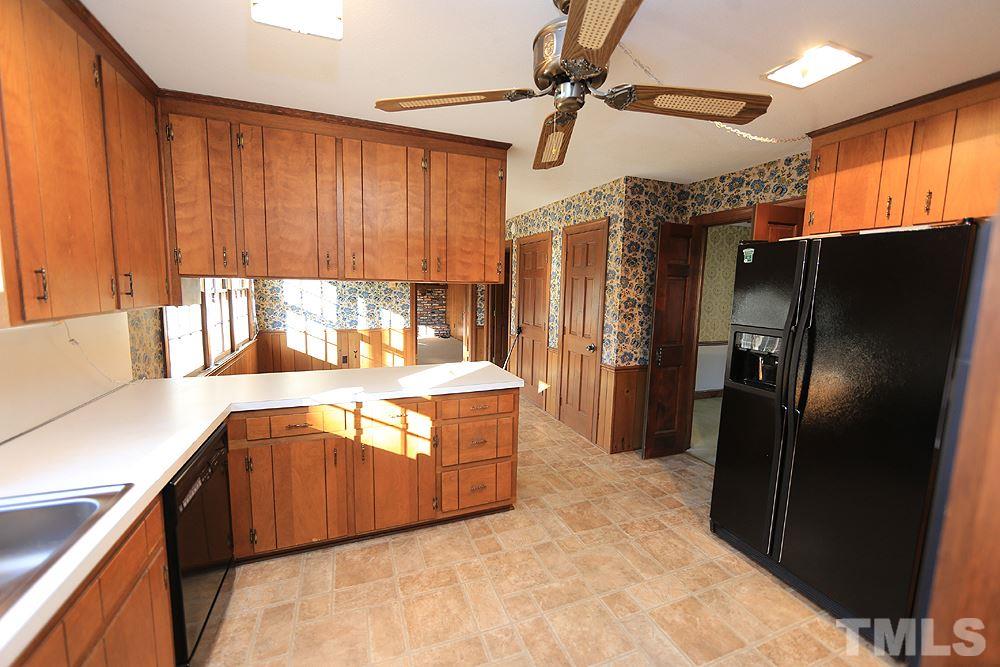 4316 Oak Park Road Raleigh, NC 27612 - Photo 8 of 30 a kitchen with stainless steel appliances granite countertop a refrigerator a sink and a stove