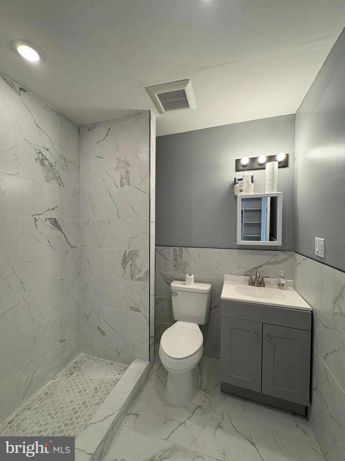 3625 North 22nd Street, Unit 1 Philadelphia, PA 19140 - Photo 6 of 10 a bathroom with a toilet sink and mirror