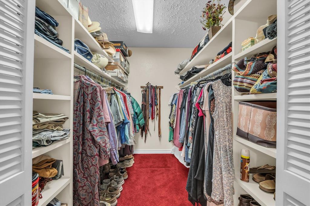 15288 Old China Spring Road China Spring, TX 76633 - Photo 15 of 40 a view of walk in closet with clothes and shoes