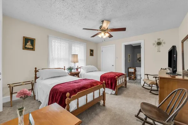 a bedroom with two beds and a chandelier