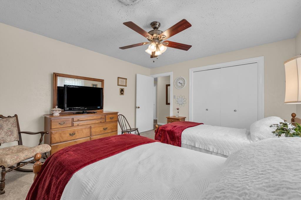 15288 Old China Spring Road China Spring, TX 76633 - Photo 18 of 40 a bedroom with a bed and a flat screen tv