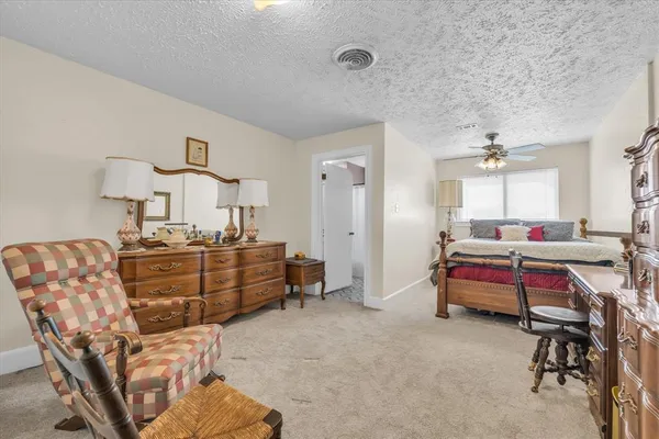 a bedroom with furniture and a chair