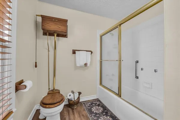 a bathroom with a toilet and a shower