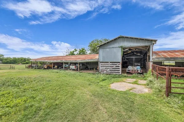 a view of a garden with a bench in a big yard