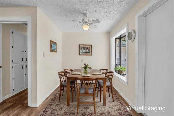 a view of a dining room with furniture and wooden floor