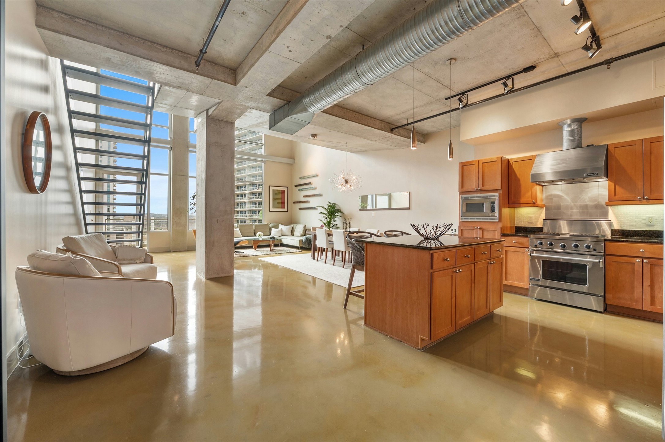 800 West 5th Street, Unit 1104 Austin, TX 78703 - Photo 30 of 31 a view of a kitchen with kitchen island stainless steel appliances wooden cabinets and a stove