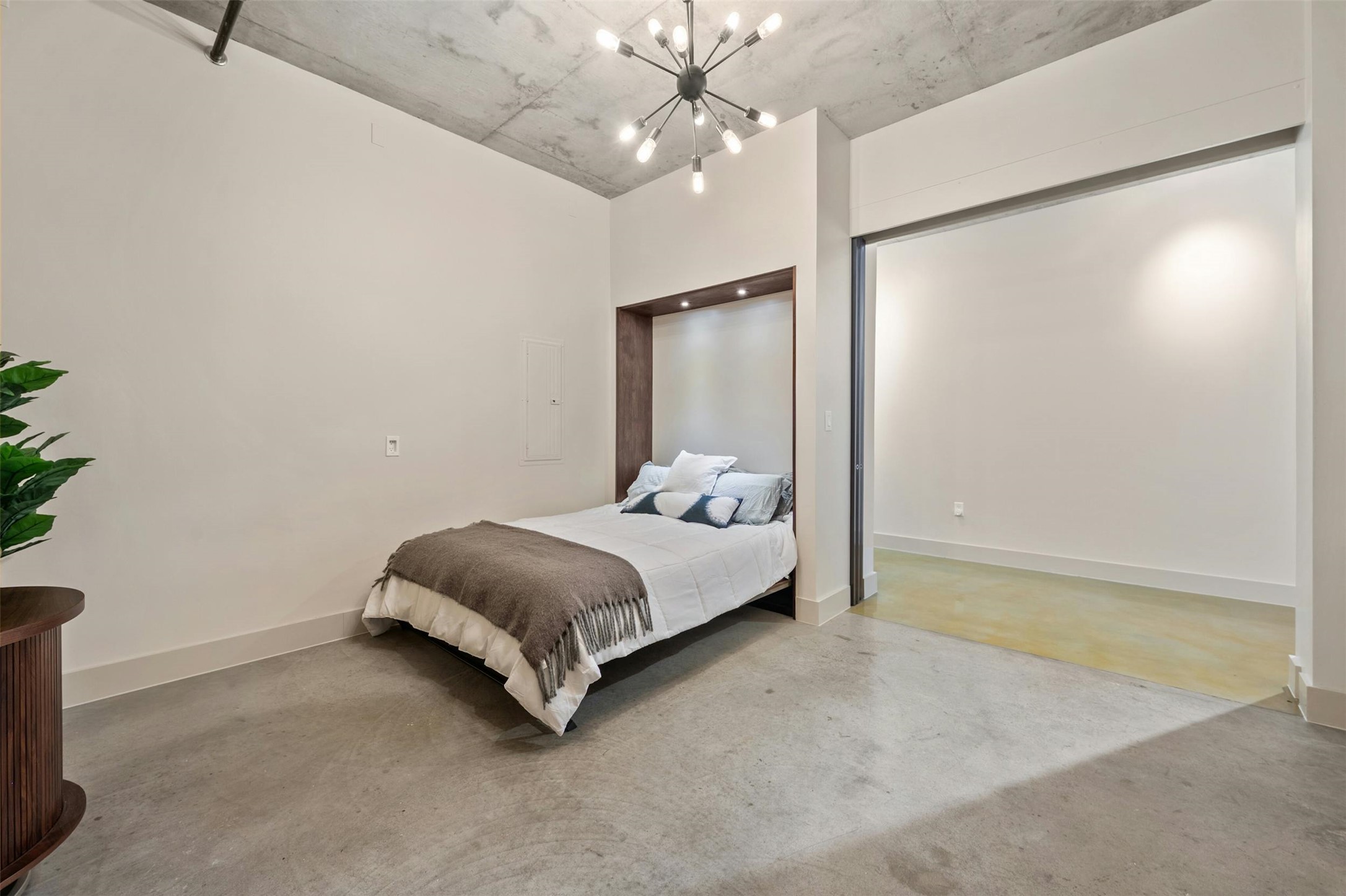 800 West 5th Street, Unit 1104 Austin, TX 78703 - Photo 22 of 31 a spacious bedroom with a bed and a chandelier