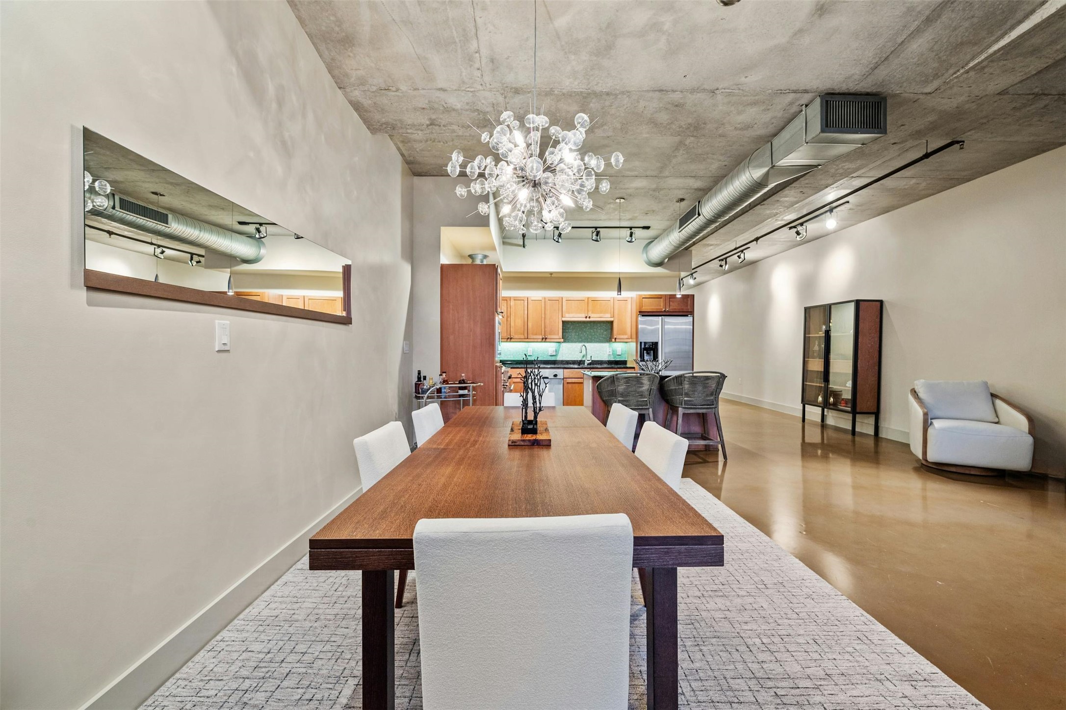 800 West 5th Street, Unit 1104 Austin, TX 78703 - Photo 8 of 31 a dining hall with couches a chandelier and kitchen view