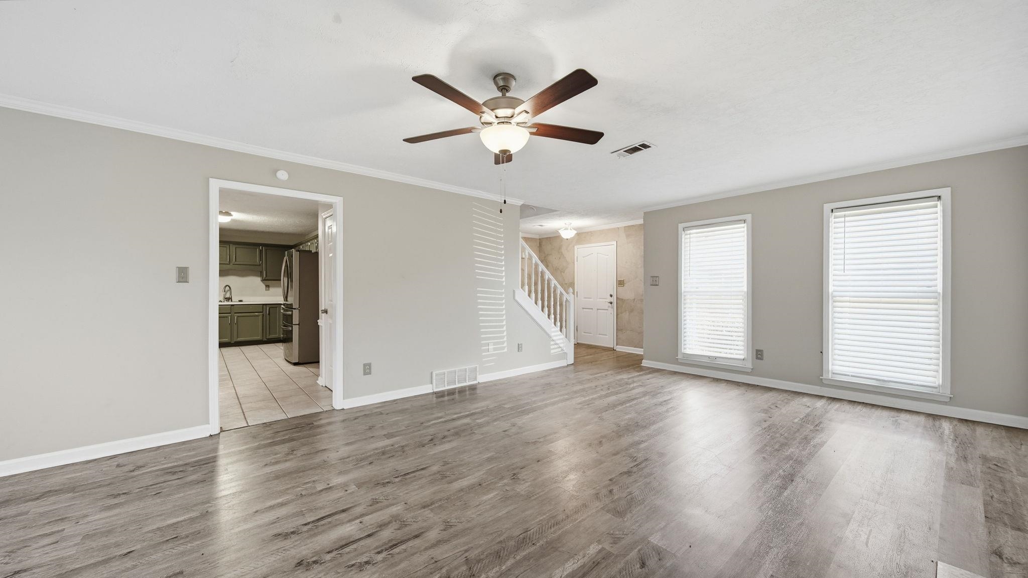1785 Candle Ridge Drive Cordova, TN 38016 - Photo 11 of 40 a view of an empty room with wooden floor and a window
