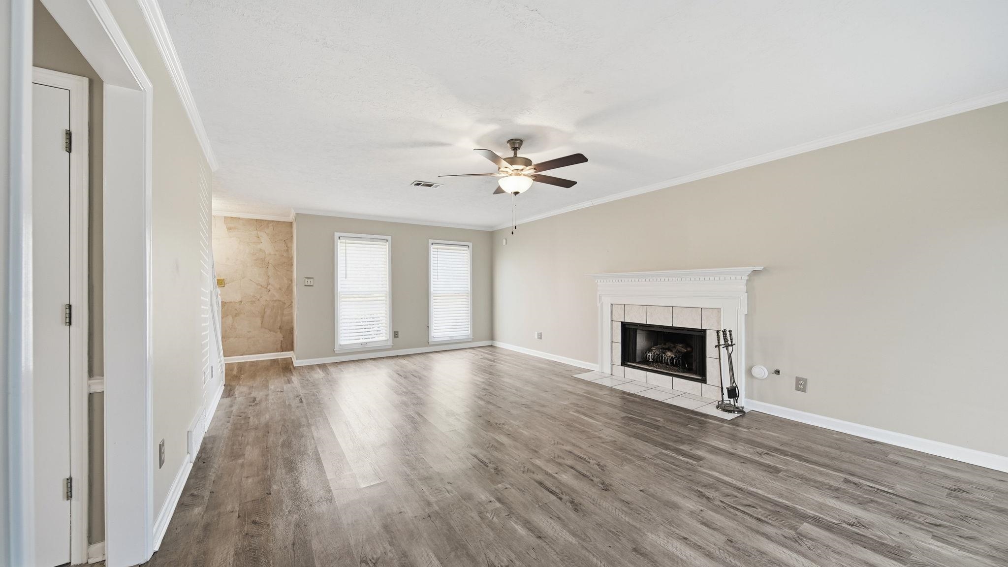 1785 Candle Ridge Drive Cordova, TN 38016 - Photo 11 of 39 a view of an empty room with wooden floor and a window