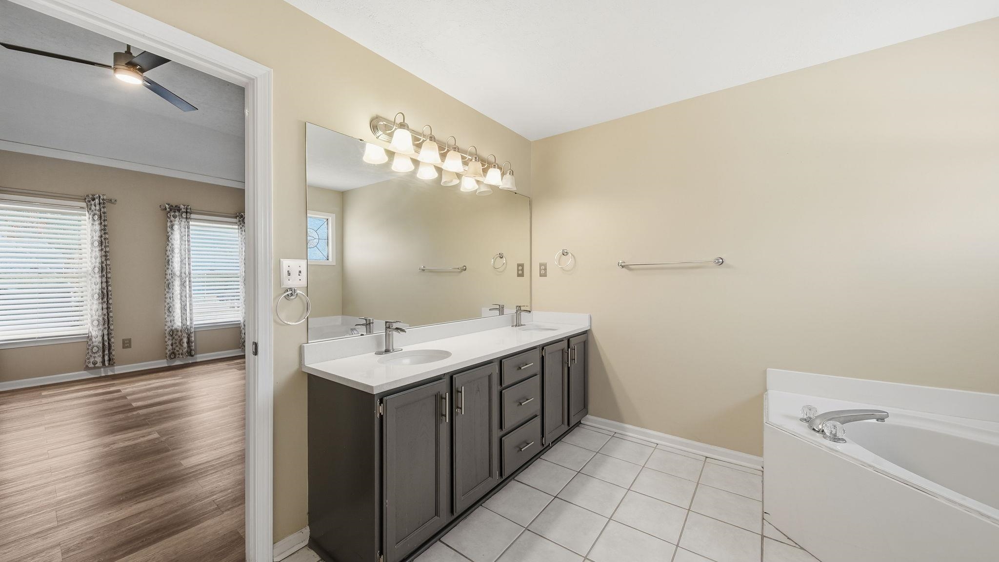 1785 Candle Ridge Drive Cordova, TN 38016 - Photo 26 of 39 Full bathroom featuring double vanity, a bath, and a ceiling fan