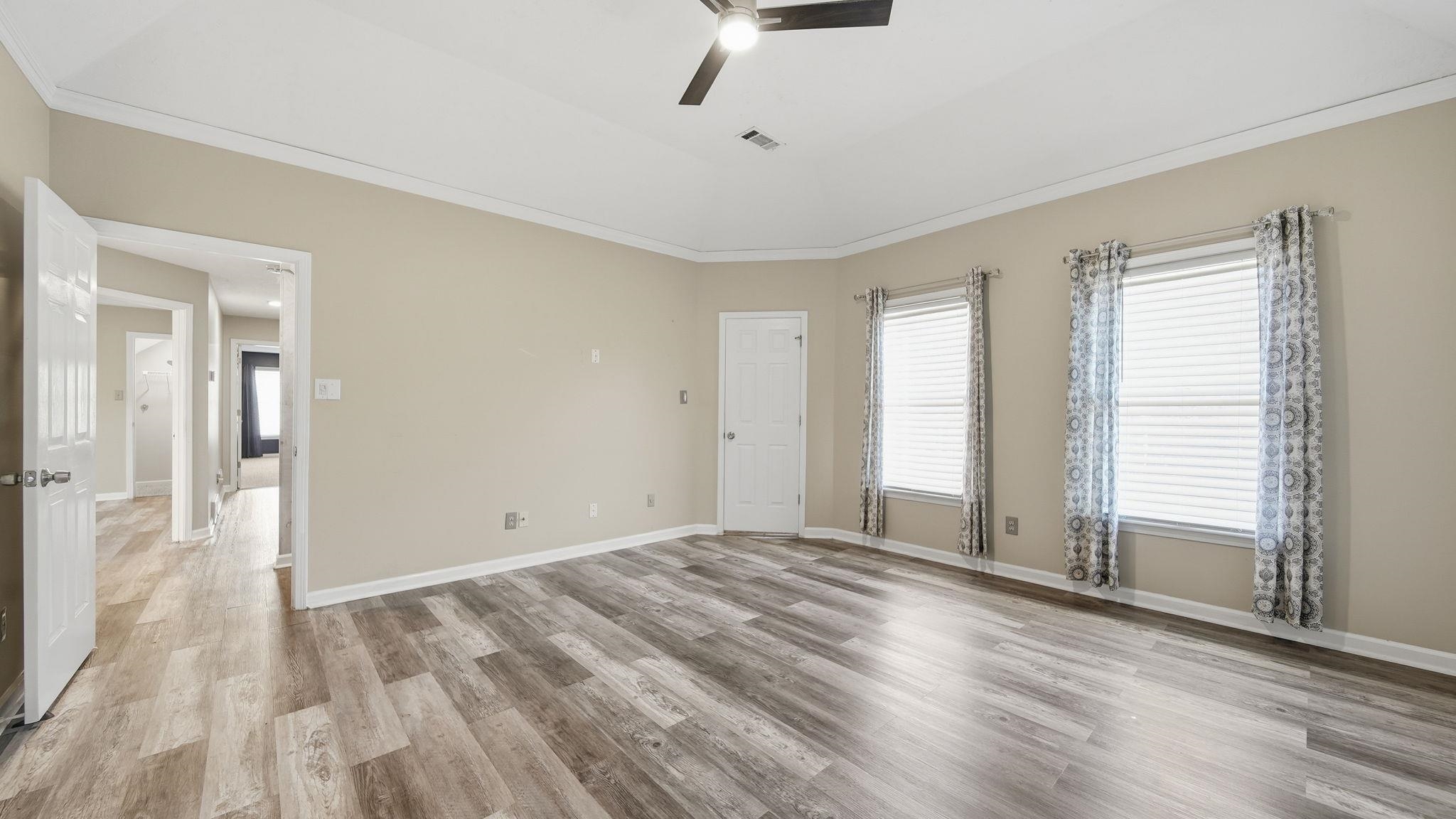 1785 Candle Ridge Drive Cordova, TN 38016 - Photo 26 of 40 a view of an empty room with wooden floor and a window