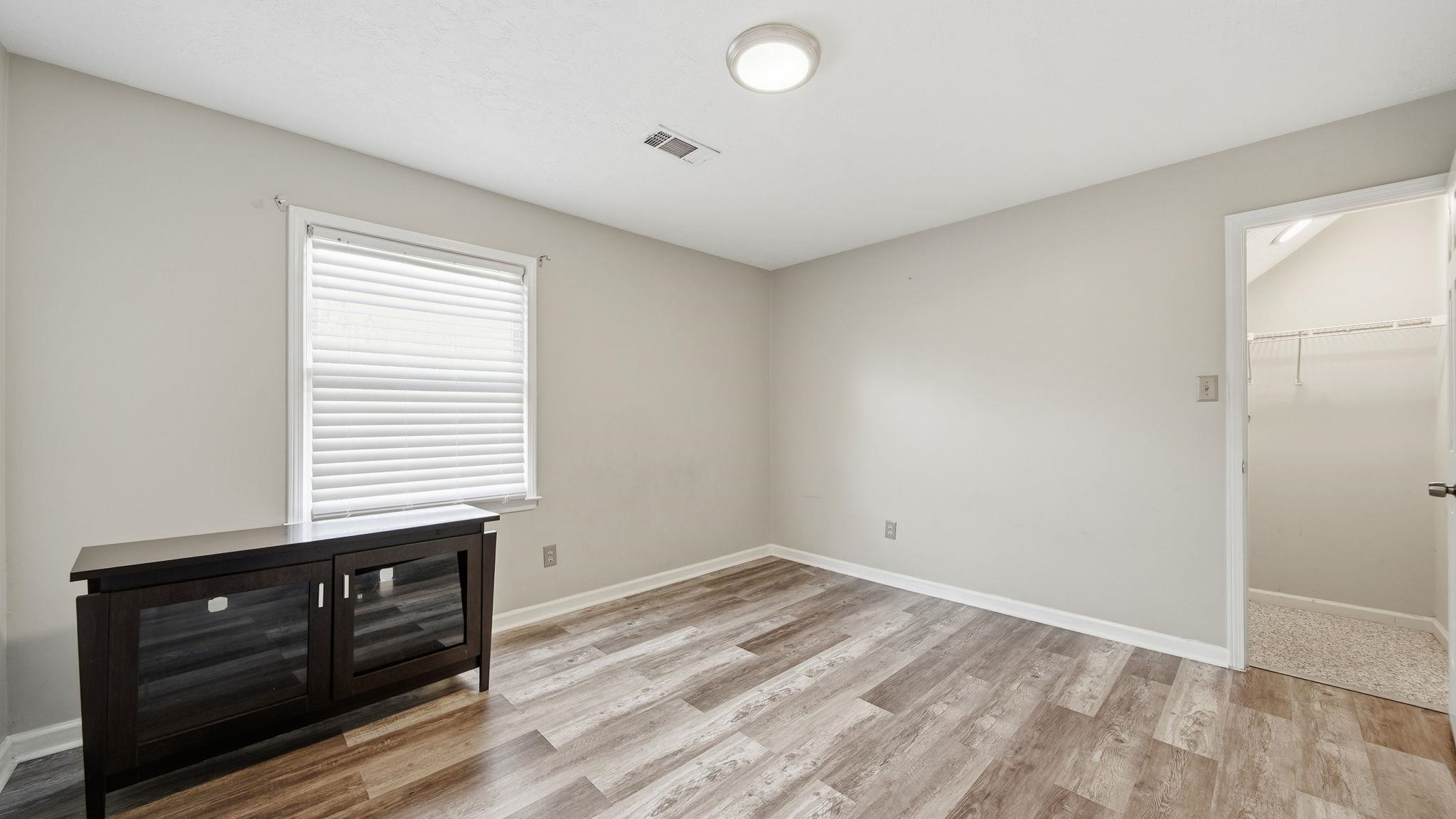 1785 Candle Ridge Drive Cordova, TN 38016 - Photo 31 of 39 Unfurnished bedroom featuring light wood-type flooring and a walk in closet