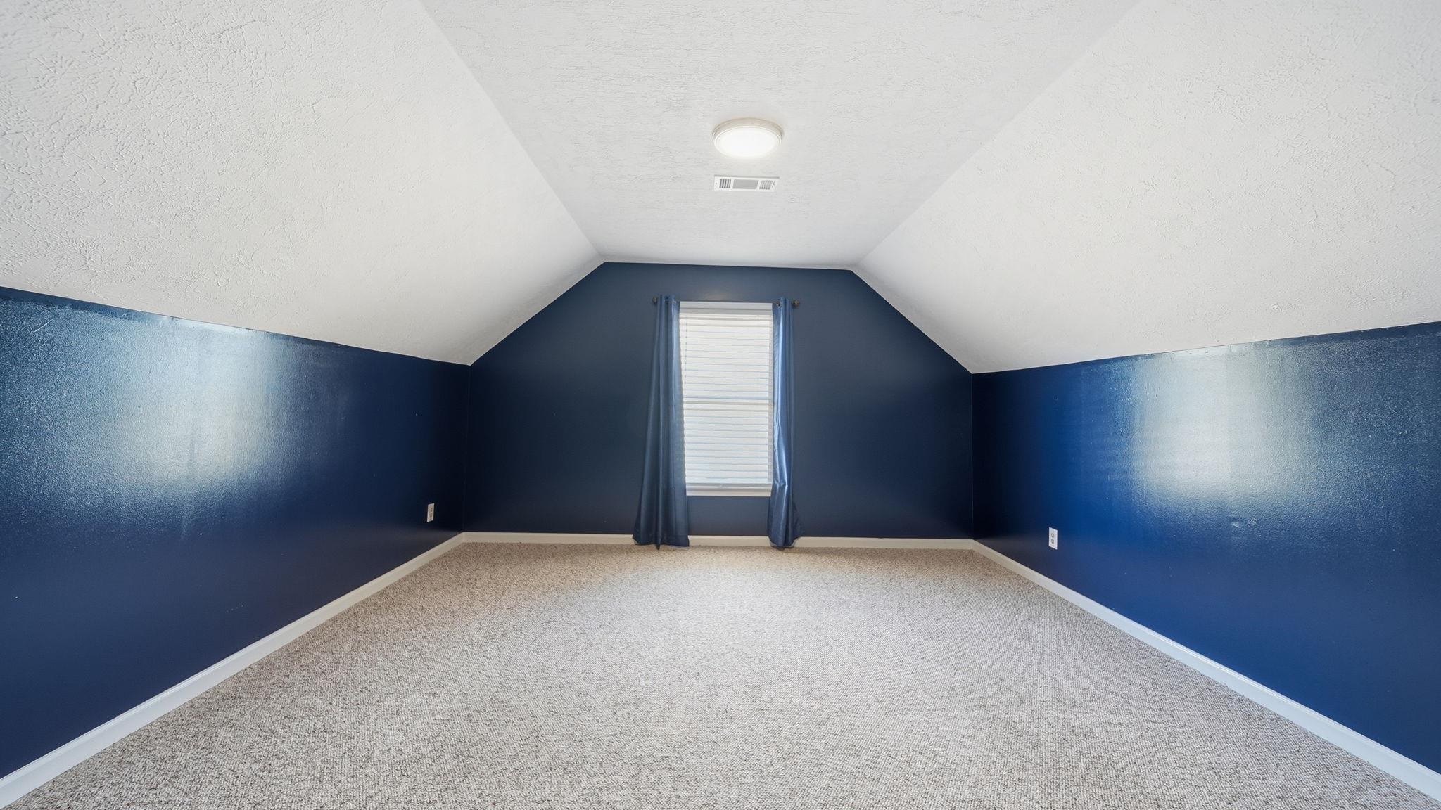1785 Candle Ridge Drive Cordova, TN 38016 - Photo 34 of 39 Bonus room with vaulted ceiling, carpet, and a textured ceiling