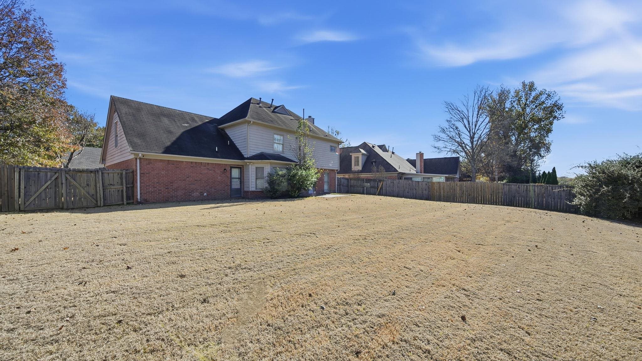 1785 Candle Ridge Drive Cordova, TN 38016 - Photo 36 of 39 View of side of home featuring brick siding and a gate