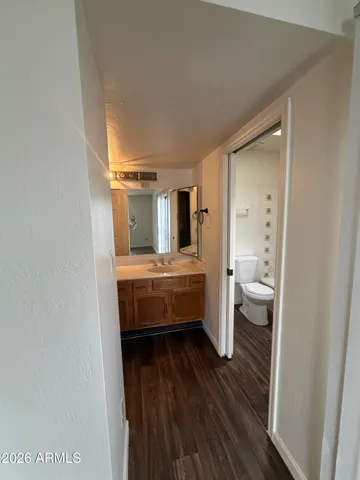 a bathroom with a toilet sink and mirror