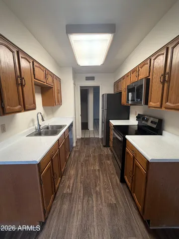 a kitchen with stainless steel appliances granite countertop a sink stove and cabinets