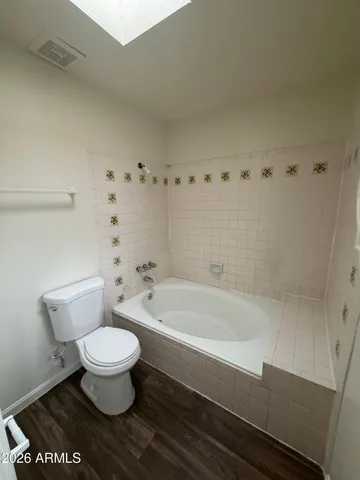 a bath room with a toilet and a bath tub