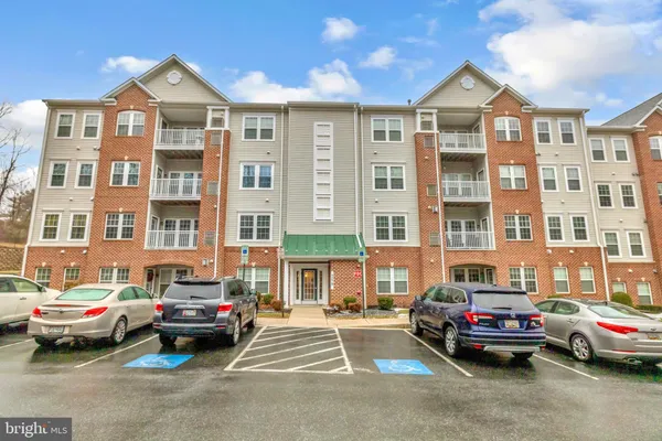 a front view of a residential apartment building with a yard