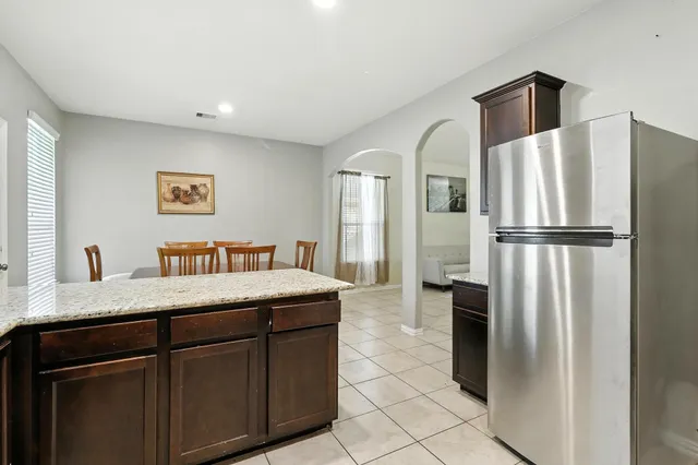 a room with a refrigerator and a sink