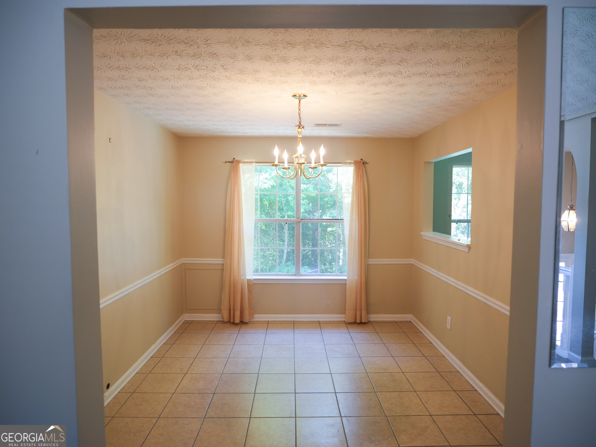 11036 Pebble Ridge Drive Hampton, GA 30228 - Photo 8 of 35 a view of an empty room with a window