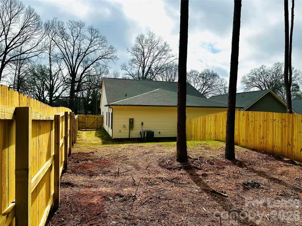 a view of a backyard with wooden fence