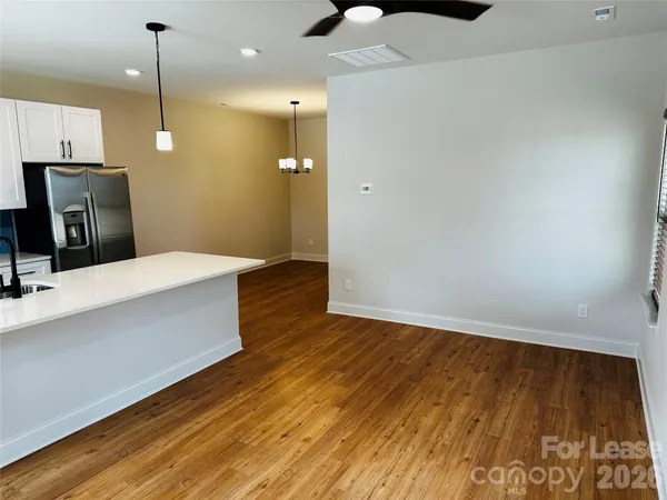a kitchen with wooden floor and window