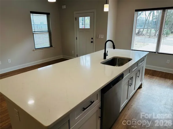 a kitchen with windows and sink