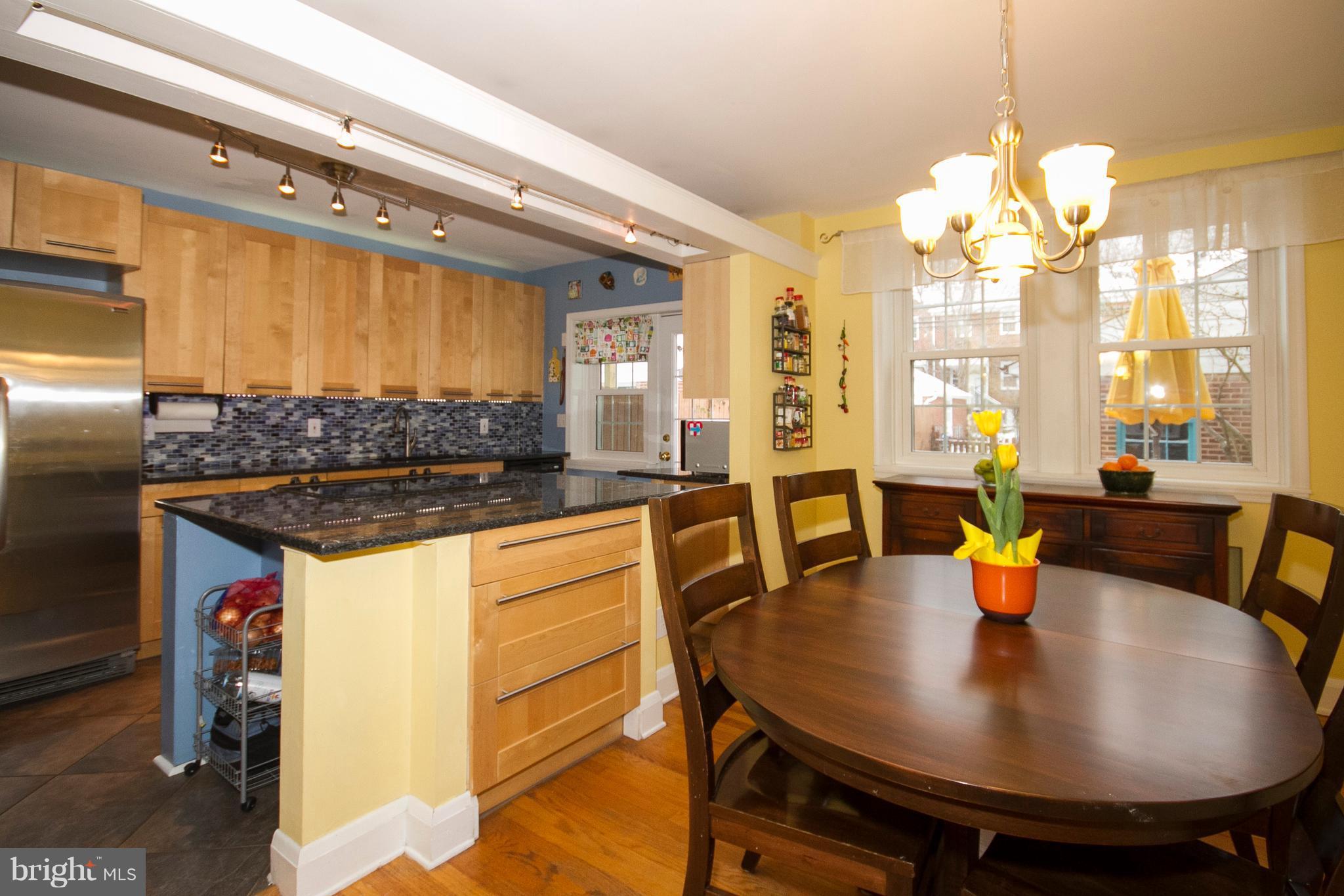326 Murdock Road Baltimore, MD 21212 - Photo 11 of 29 a kitchen with a table chairs and a chandelier