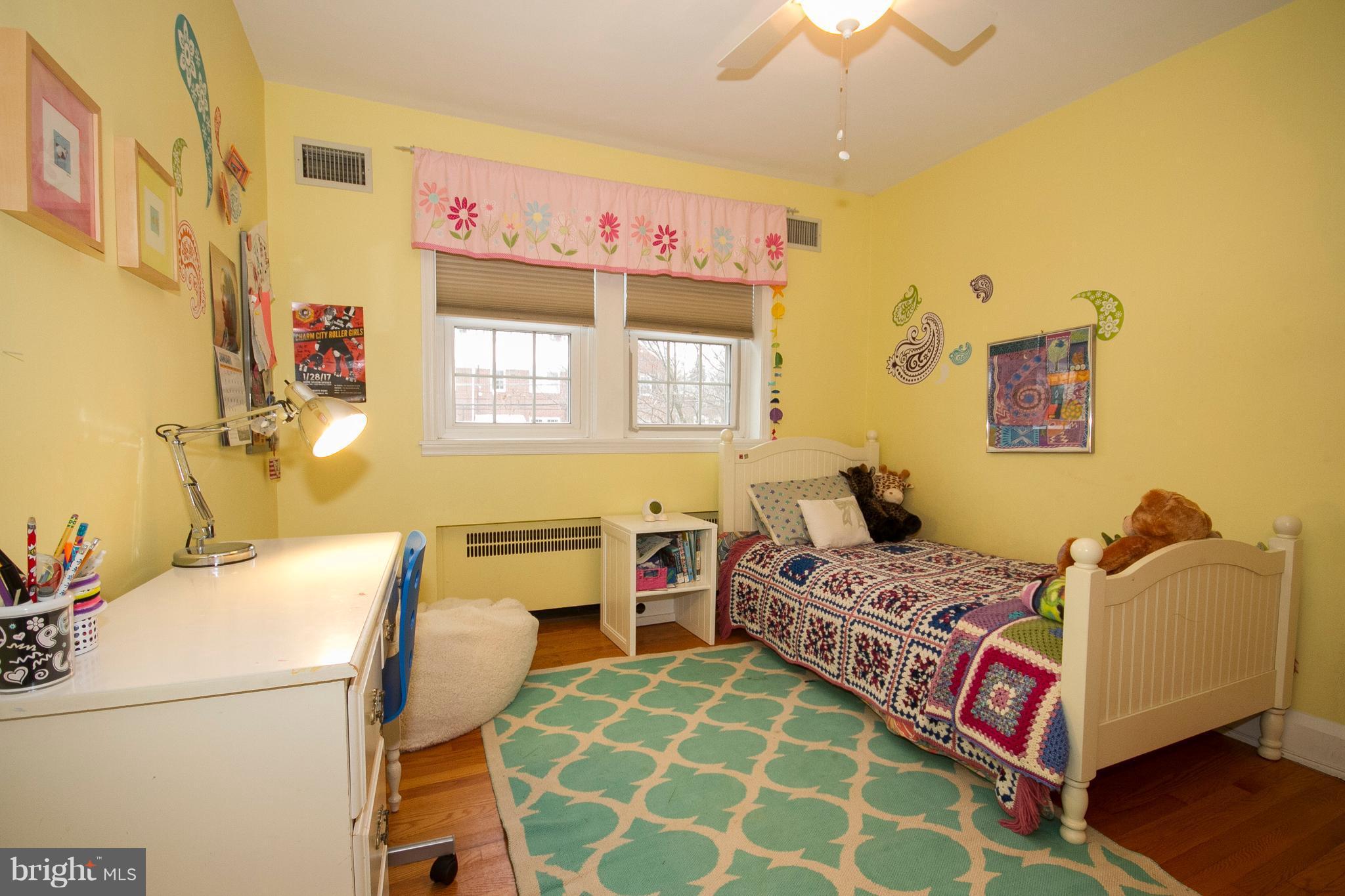 326 Murdock Road Baltimore, MD 21212 - Photo 16 of 29 a bedroom with a bed and a chandelier