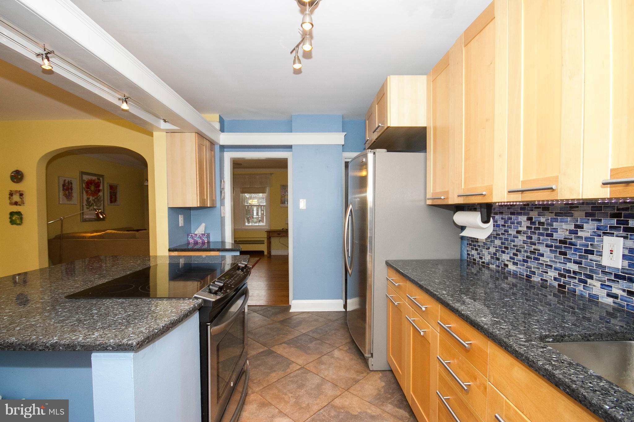 326 Murdock Road Baltimore, MD 21212 - Photo 8 of 29 a kitchen with granite countertop a sink and a refrigerator