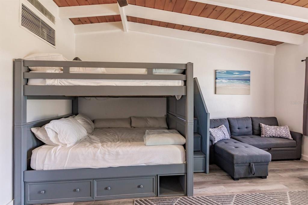 6006 Midnight Pass Road, Unit 2 Sarasota, FL 34242 - Photo 4 of 15 a bedroom with a bed and a potted plant