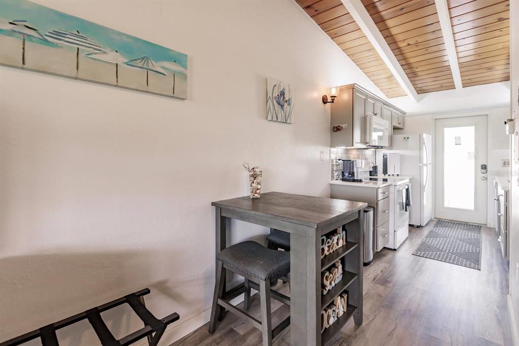 6006 Midnight Pass Road, Unit 2 Sarasota, FL 34242 - Photo 5 of 15 a view of a kitchen with furniture and wooden floor
