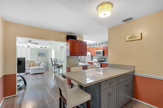 a kitchen with a sink cabinets and wooden floor