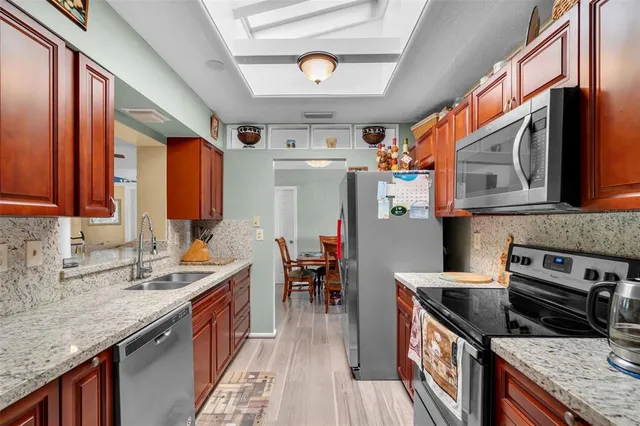 a kitchen with stainless steel appliances granite countertop a stove and a sink