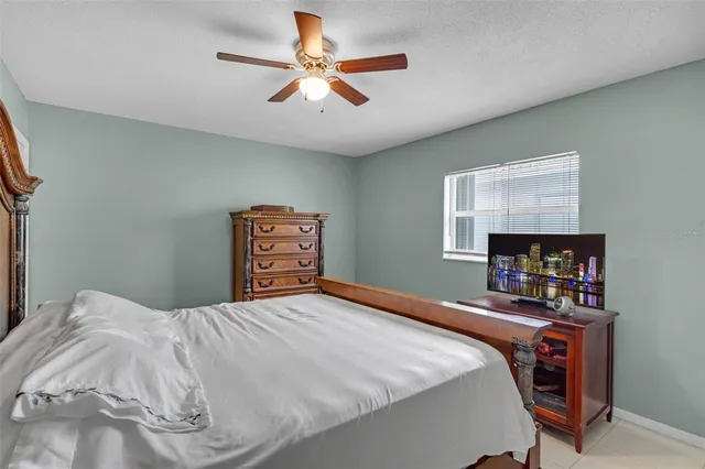 a bedroom with a bed a dresser and a book shelf