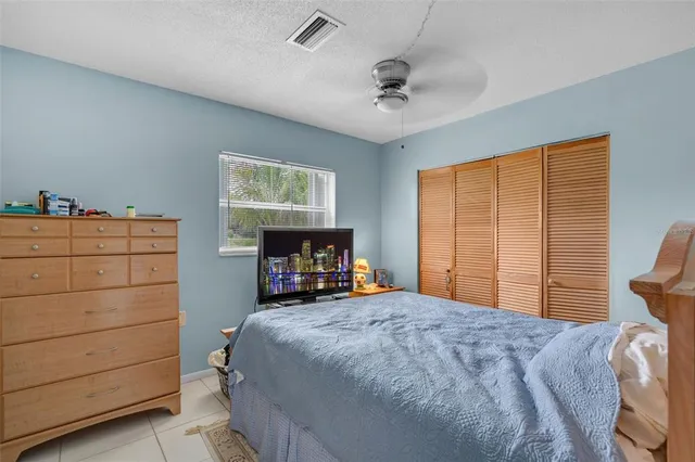 a bedroom with a bed and a television