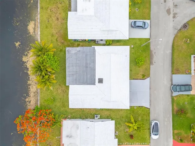 a view of a swimming pool with a patio and a yard
