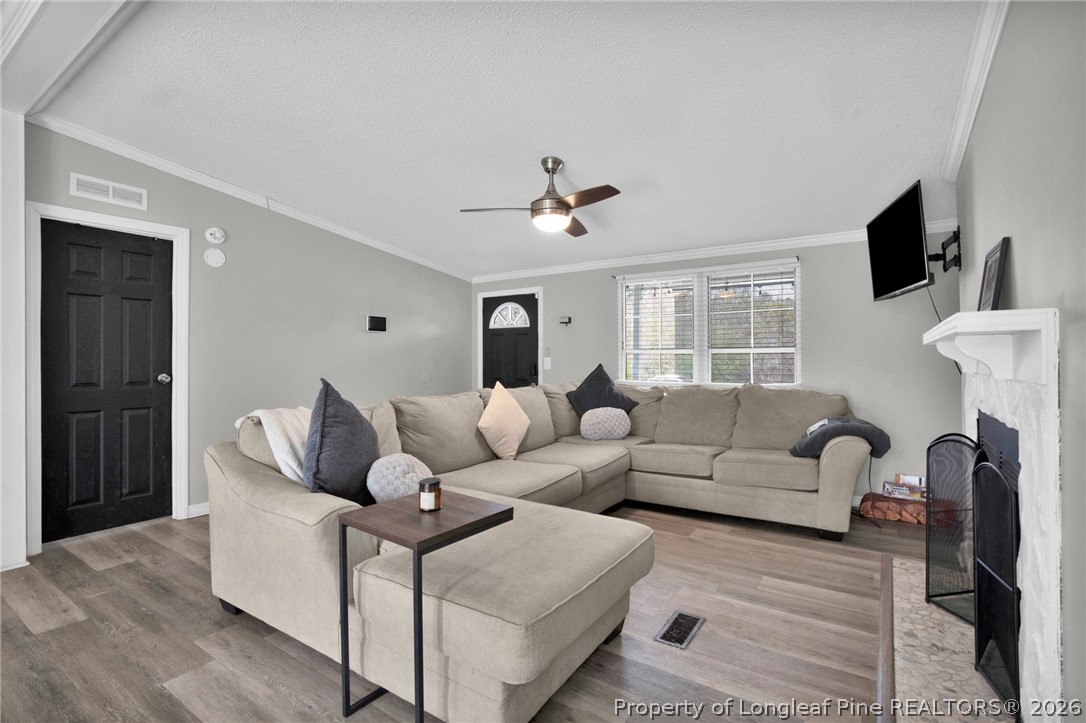 518 Inverary Drive Raeford, NC 28376 - Photo 7 of 30 a living room with furniture a ceiling fan and a window