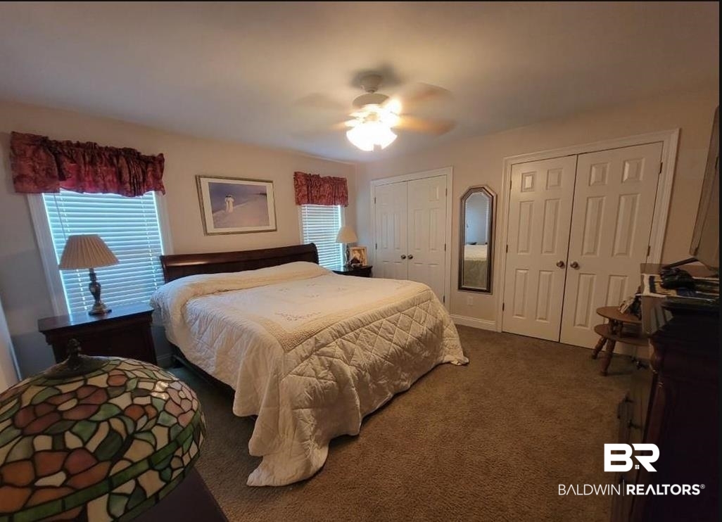 16311 Old Brady Road Bay Minette, AL 36507 - Photo 10 of 38 Bedroom featuring dual windows with blinds, ceiling fan, and two sets of bi-fold closet doors