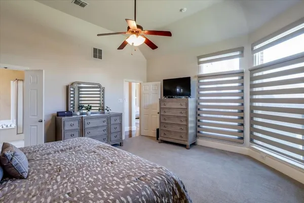 a bedroom with a bed dresser and a window