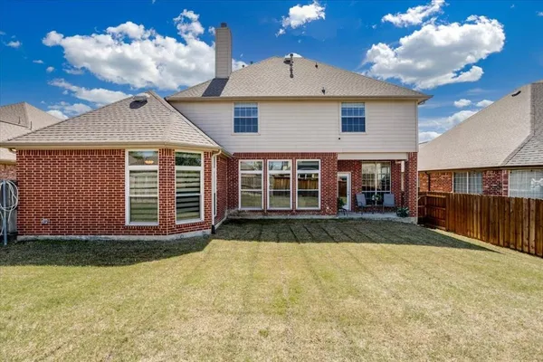 a view of a house with a yard and garage