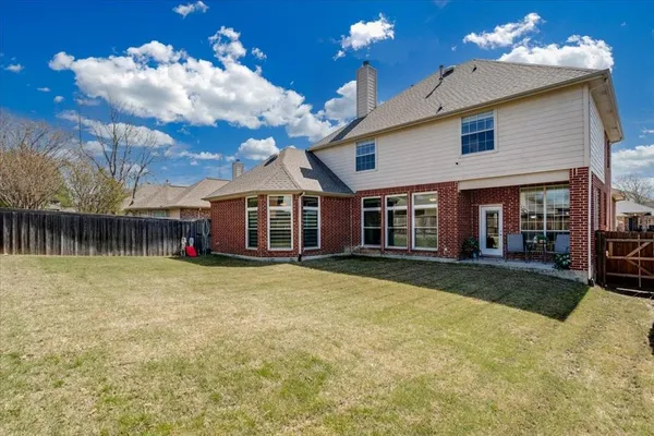 a front view of a house with swimming pool having outdoor seating