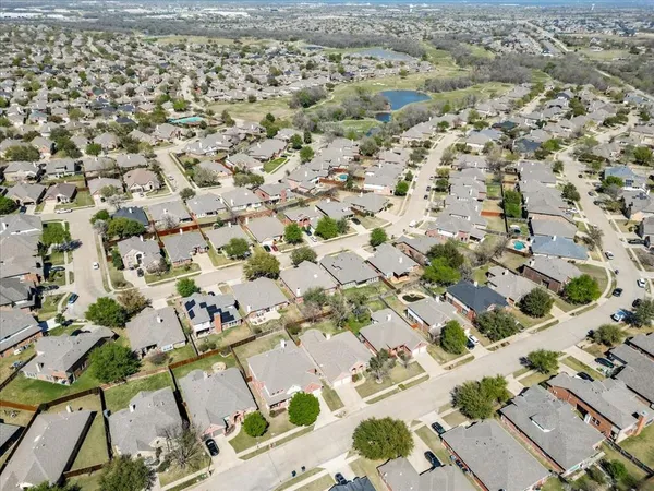 an aerial view of residential houses with yard