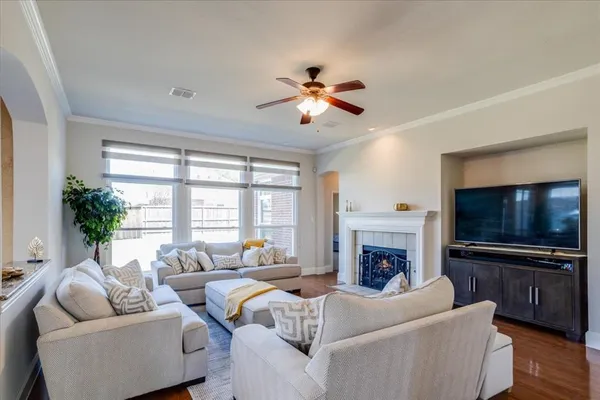 a living room with furniture a fireplace and a flat screen tv