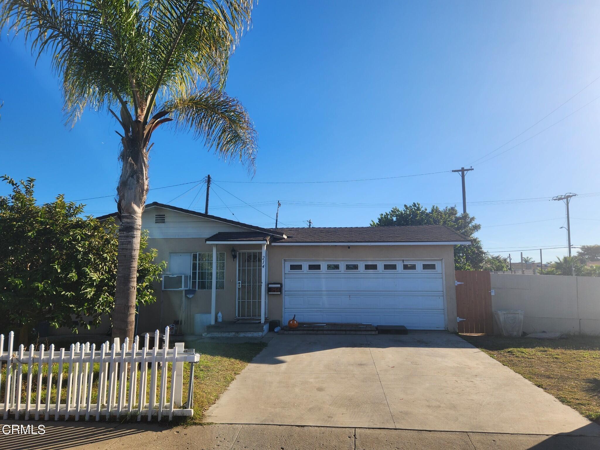 214 Smith Street Oxnard, CA 93033 - Photo 2 of 8 a front view of a house with a garden